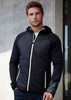 A black puffer jacket with a hood, featuring zippered pockets and a white zipper detail, displayed on a model.