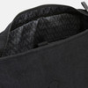 A black canvas backpack with a textured interior lining and a zippered opening. It features a logo.