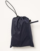 A navy blue waterproof rain pants packed in a drawstring bag with a toggle. Features a logo on the bag.