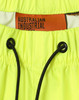Bright yellow lightweight nylon waterproof rain pants with a drawstring waistband and a logo tag inside.