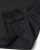 A close-up of a black sustainable jacquard knit polo shirt showcasing the fabric and sleeve design.