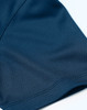 A close-up of a navy blue sustainable jacquard knit polo showing its textured fabric and stitching details.