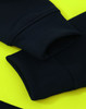 A close-up of a black fleece hoodie with bright yellow accents, featuring ribbed cuffs and a logo.