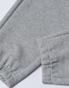 A pair of grey unisex sweatpants featuring an elasticated cuff and a logo on the waistband.
