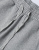 A close-up of grey unisex sweatpants with an elastic waistband and drawstring detail. The fabric appears soft and comfortable.