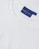 A white premium cotton short-sleeve tee shirt with a branded tag.