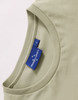 A light green ladies' premium cotton t-shirt showcasing a rounded neckline and a label with branding.
