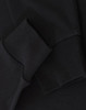A close-up of black long-sleeve cotton tee shirt cuffs, featuring a visible logo.
