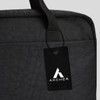 A black laptop bag featuring a top handle and a tag with a logo. The material has a textured finish.