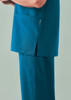 A unisex pulse v-neck scrub top in teal, featuring side slits and a pocket.