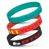 Three silicone wristbands in teal, red, and black, featuring debossed text and logos.