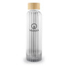 A drink bottle made of clear glass with a ribbed design and a natural wooden lid, featuring a logo.
