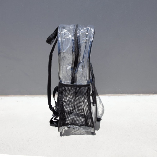 A clear stadium backpack in transparent PVC with black straps and a mesh pocket at the bottom.