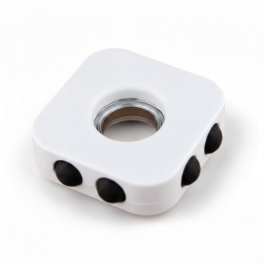 A white decompression finger spinner with three black buttons and a central bearing. It has a smooth, square design.