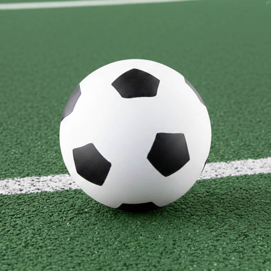 A high bounce soccer ball featuring a classic black and white design, resting on a green surface.