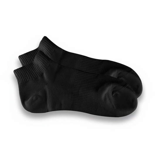 A pair of black ankle grip socks with textured detailing and a logo on one sock.