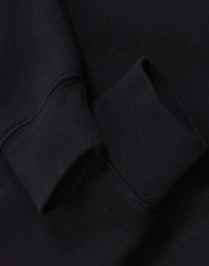 A black half-zip collar fleecy sweat featuring a close-up of the cuff detail. It includes a branding logo.