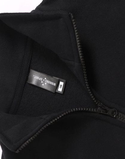 A black fleecy sweatshirt featuring a half zip collar, with an inner label and a subtle logo.