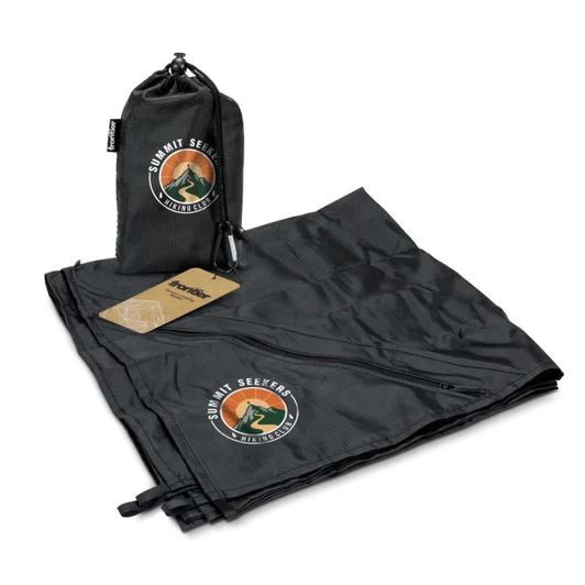 A black camping blanket laid out, with a matching carry pouch and a logo displayed on both items.