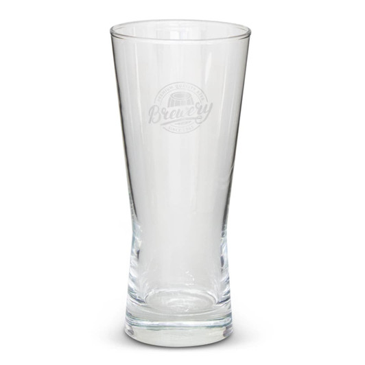 A clear glass beer glass with a tapered design and an etched logo on the front.