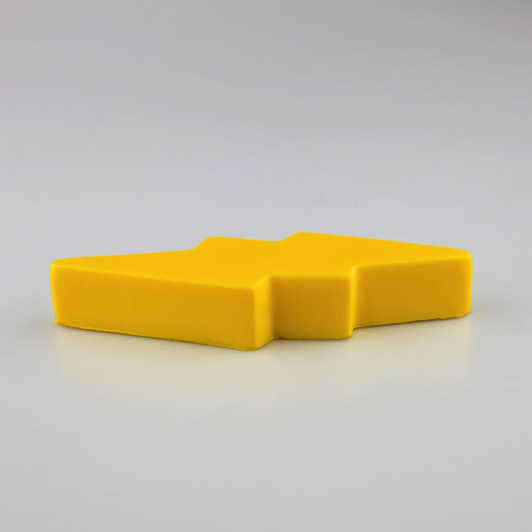 A yellow stress relief toy shaped like a lightning bolt, with a smooth, solid design.