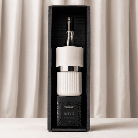 A wine bottle in a white and silver insulated cooler, displayed in a black box.