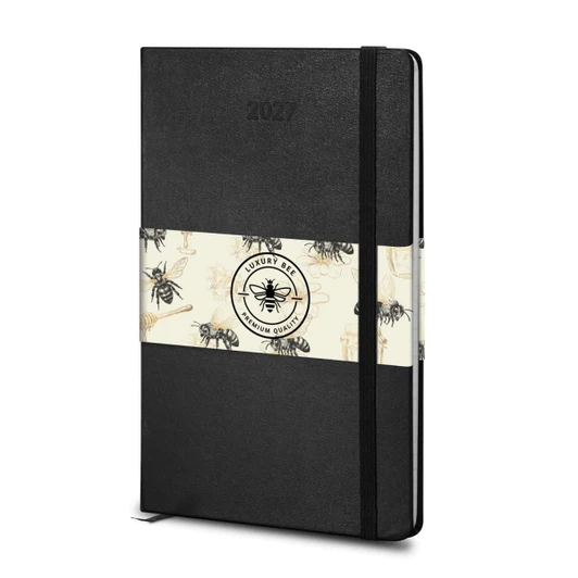 A black Moleskine 2027 planner with a decorative band featuring bees, designed for weekly planning.