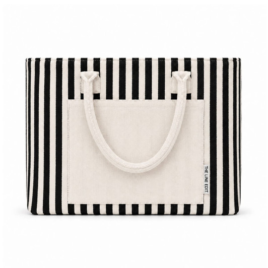 A striped tote bag in black and cream with sturdy handles and a front pocket, featuring a logo.