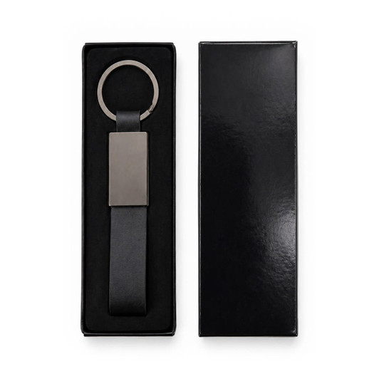 A black keytag with a sleek silver ring and rectangular pendant, displayed in a black box.