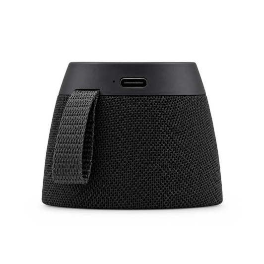 A portable speaker in black fabric with a USB-C port and a woven strap on the side.