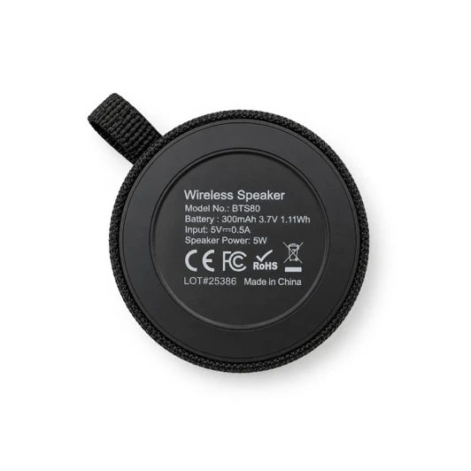 A round black wireless speaker with a textured surface and a hanging loop, featuring technical specifications on the back.