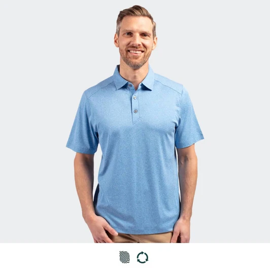 A men's polo in light blue, featuring a collar, buttons, and a logo. Model is smiling and standing.