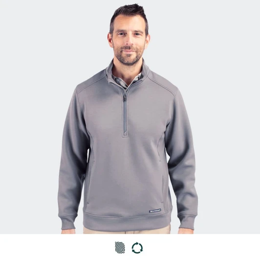 A man wearing a grey Cutter & Buck Roam men's half zip jacket, featuring a collar and a logo on the chest.