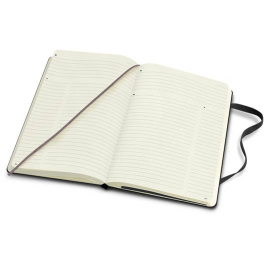 A large Moleskine Pro hard cover notebook with blank lined pages and a black cover. It includes a ribbon bookmark.