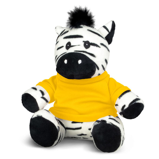 A zebra plush toy with black and white stripes, wearing a yellow shirt and featuring a tuft of fur on its head.