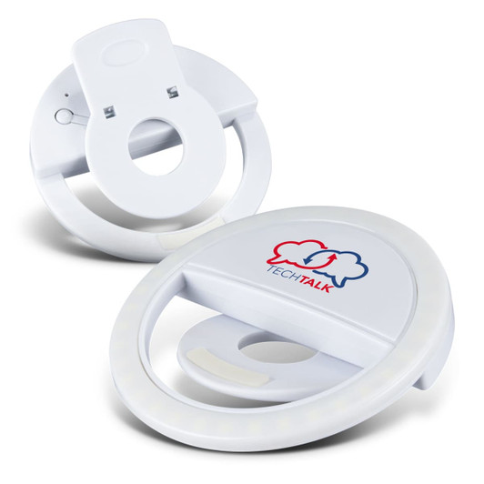 A white selfie phone light with a circular design, featuring a logo on the front and a clip for attachment.
