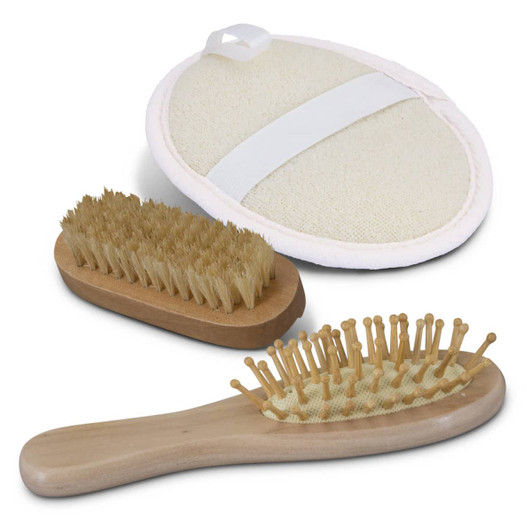A travel set featuring a wooden hairbrush, a smaller wooden brush, and a round massage brush with a strap.
