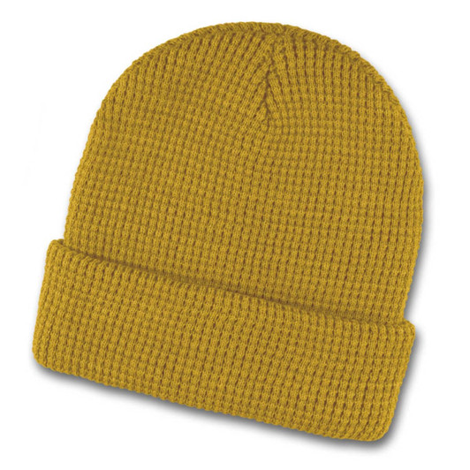 A mustard yellow waffle beanie featuring a ribbed texture and a folded cuff. It has a logo present.