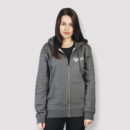 A grey unisex hoodie with a front zipper and a logo on the chest. The model stands against a light grey background.