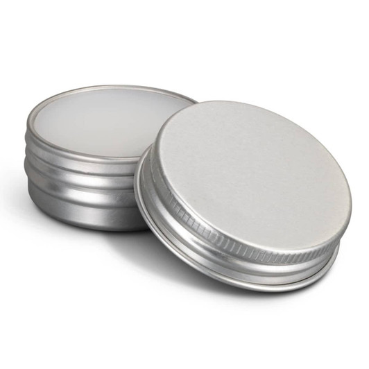 Two silver lip balm tins, one open to reveal the white balm inside. Both tins have a metallic finish.