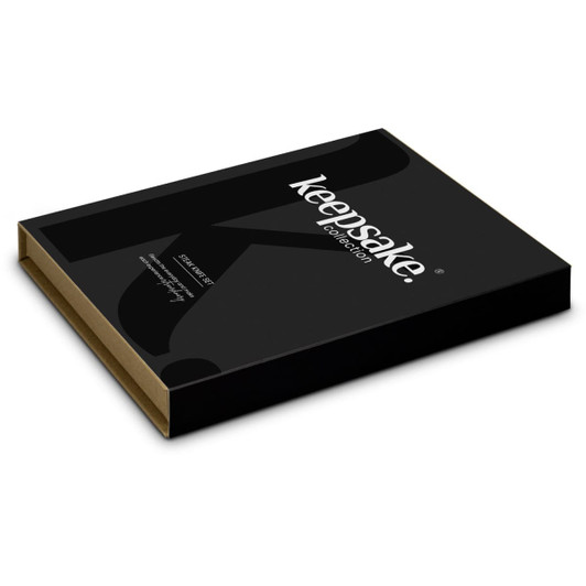 A black box with a gold interior, featuring a logo, designed for the Keepsake Steak Knife Set.