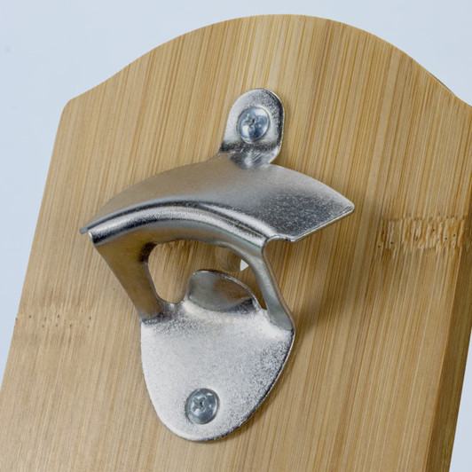 A drink bottle opener featuring a metallic opener mounted on a natural bamboo background. It has a logo.