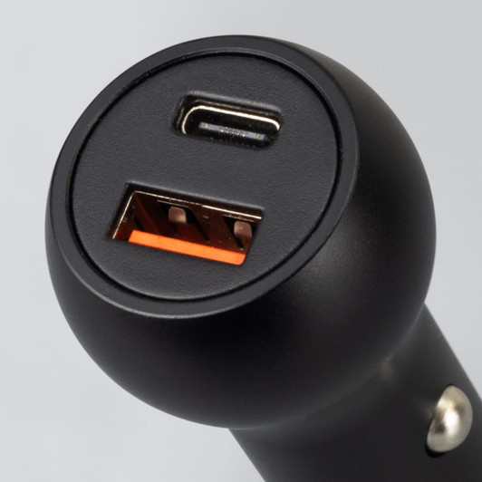 A black USB car charger featuring one USB-A port and one USB-C port. It has a round design and a sleek finish.