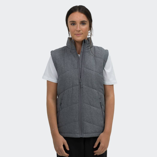 A grey puffer vest with a front zipper and side pockets, worn by a model against a plain background.