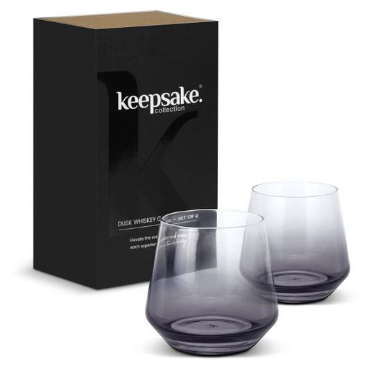 A set of two purple whiskey glasses inside a box, featuring a logo on the packaging.