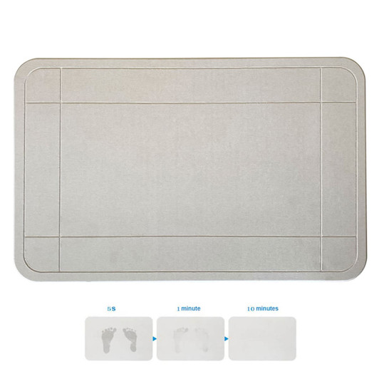 A grey bath mat with a textured surface, featuring a logo. It has bordered sections and shows footprints.