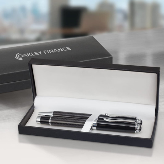 A sleek black pen with silver accents inside a black presentation box, featuring a logo on the lid.