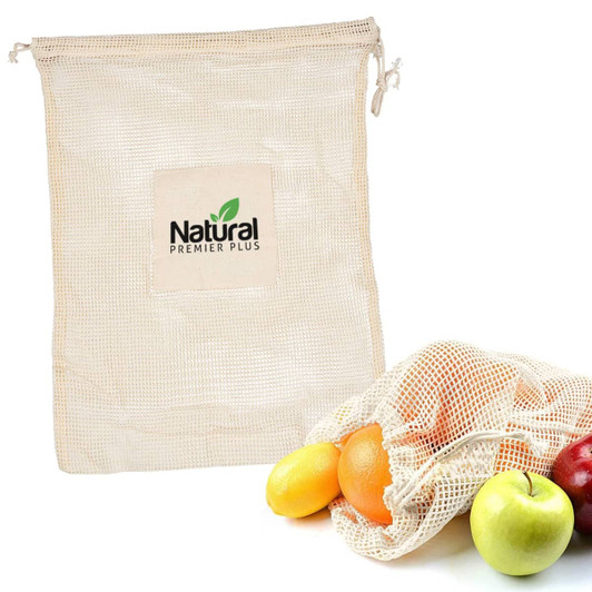 A cream mesh produce bag with a logo, containing various fruits including apples and oranges.