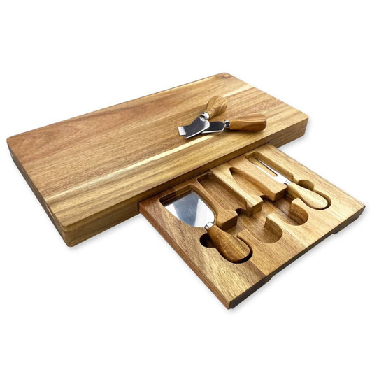 A wooden cheeseboard set in light brown with six cheese knives nestled in a pull-out drawer.