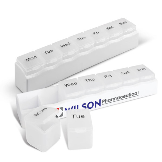 A medication organiser in white with compartments labelled for each day of the week and a logo.
